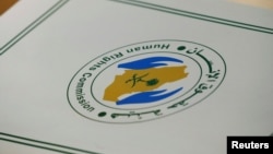 FILE - A folder with a logo of the Human Rights Commission of Saudi Arabia is pictured on a desk during the Universal Periodic Review of Saudi Arabia by the Human Rights Council at the United Nations Office in Geneva, Switzerland.