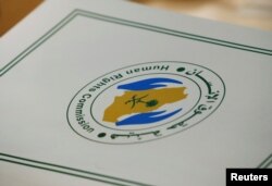FILE - A folder with a logo of the Human Rights Commission of Saudi Arabia is pictured on a desk during the Universal Periodic Review of Saudi Arabia by the Human Rights Council at the United Nations Office in Geneva, Switzerland.