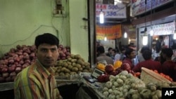 A vegetable seller, Vijay Kumar, waits for customers in his shop in an upscale INA market, in New Delhi, India (File Photo)