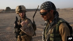 FILE - U.S. Marine 1st Lt. Zachary Bennett talks with Afghan interpreter during a joint patrol in Helmand province, southern Afghanistan.