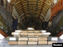 FILE - Boxes of ammunition are seen inside a Russian aircraft at the International Kabul Airport, Afghanistan, Feb. 24, 2016. Afghan officials took delivery of 10,000 automatic rifles and millions of rounds of ammunition as a gift from Russia.