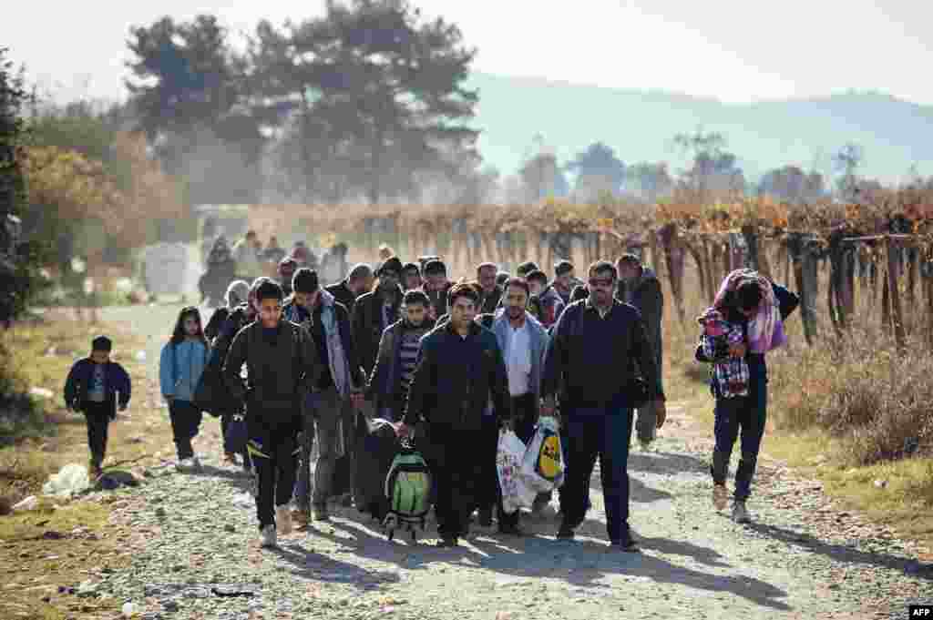 Migrants and refugees walk after crossing the Greek-Macedonian border near Gevgelija.