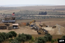 File photo taken on May 8, 2018, shows vehicles and structures of the US-backed coalition forces in the northern Syrian town of Manbij.