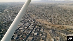 FILE - This May 1, 2015 photo shows an aerial view of the US Mexico border showing Calexico, Calif. below and Mexicali, Mexico above.