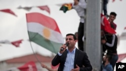 Ahead of Sunday's election, Selahattin Demirtas, head of the pro-Kurdish Peoples' Democratic Party (HDP), delivers a speech from the top of his election campaign bus at a rally in Istanbul, Turkey, June 6, 2015.