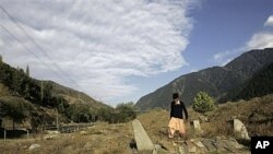 Farmer Atta Mohammed walks past unmarked graves in Kashmir, Oct. 7, 2009 (file photo).