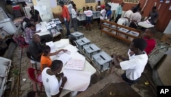 FILE - Election workers at a voting station set up in a government office building in Port-au-Prince, Haiti.