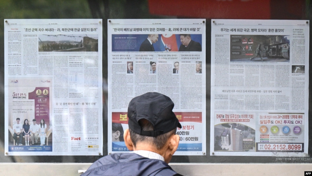Čovjek gleda u novine postavljene u Seulu 21. oktobra 2024., u kojima se izvještava o odluci Sjeverne Koreje da rasporedi hiljade vojnika na ukrajinske linije fronta.