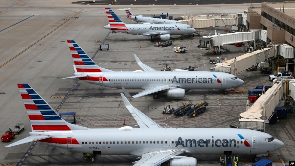 FILE - American Airlines planes arrive at Phoenix Sky Harbor International Airport in Phoenix, July 17, 2019. The airline said two labor unions ignored a judgeâs order to quickly end a work slowdown by mechanics.