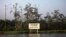 A warning sign belonging to the company Royal Dutch Shell is seen along the Nembe creek in Nigeria's oil state of Bayelsa Dec. 2, 2012.