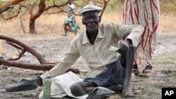 Gatdin Bol, 65, who fled fighting and now survives by eating fruit from the trees, sits under a tree in the town of Kandak, South Sudan, May 2, 2018.