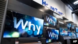 A 249-centimeter Samsung television, left, sits by others of various sizes on display at a Best Buy store in Dallas, Oct. 25, 2024.