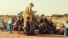 FILE - Displaced Sudanese, who fled the Zamzam camp, gather near the town of Tawila in North Darfur on Feb. 14, 2025. On Feb. 24, 2025, Doctors Without Borders halted its operations in the camp due to an escalation of fighting in the area. 