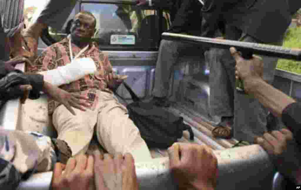 Uganda's Forum for Democratic Change leader Kizza Besigye sits on the back of a police pick-up truck after he was arrested at Kasangati suburb of the capital Kampala, April 18, 2011. Ugandan opposition leader Besigye was arrested on Monday during a protes
