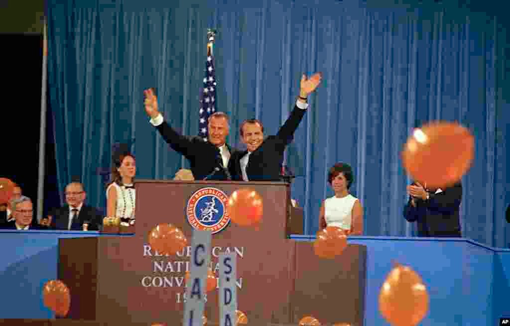 FILE - Republican presidential candidate Richard Nixon, waving right, and his running mate, Spiro Agnew, at the podium during the Republican National Convention at the Miami Beach Convention Center in Florida, Aug. 8, 1968. 