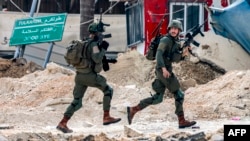 Israeli soldiers take position during an army operation in Tulkarm in the north of the occupied West Bank on Aug. 29, 2024.