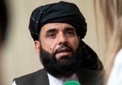 FILE - Suhail Shaheen, spokesman for the Taliban's political office in Doha, speaks to the media in Moscow, May 28, 2019.