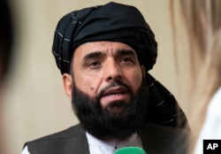 FILE - Suhail Shaheen, spokesman for the Taliban's political office in Doha, speaks to the media in Moscow, May 28, 2019.