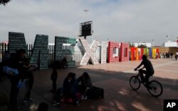 FILE -The words "Tijuana, Mexico" stand on the Mexican side of the border with the U.S. where migrants wait to apply for asylum in the U.S., in Tijuana, Mexico, June 9, 2019.