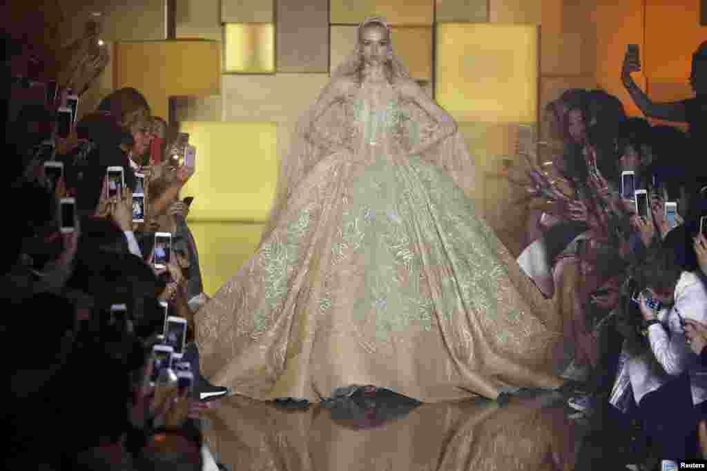 A model presents a wedding dress creation by Lebanese designer Elie Saab as part of his Haute Couture Fall Winter 2015/2016 fashion show in Paris, France.