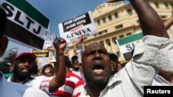 FILE - A group of Sri Lankan Muslims protest the U.N. and U.S resolution against Sri Lankan war crimes, during a demonstration in Colombo, March 26, 2014. 