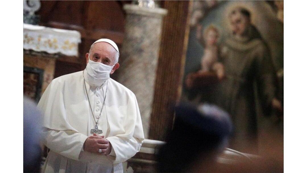 FILE - Pope Francis wears a face mask as he attends an inter-religious prayer service for peace in the Basilica of Santa Maria in Aracoeli, a church on top of Rome's Capitoline Hill, in Rome, Italy, Oct. 20, 2020.