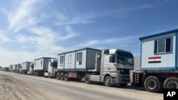 Scores of trucks carrying mobile homes line up on the Egyptian side of the Rafah crossing in preparation for entering Gaza, at the Rafah border crossing, Egypt, Feb. 18, 2025.