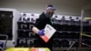 U.S. -- Election worker Gareth Fairchok removes ballots from a sorting machine as vote-by-mail ballots for the August 4 Washington state primary are processed at King County Elections in Renton, Washington on August 3, 2020.