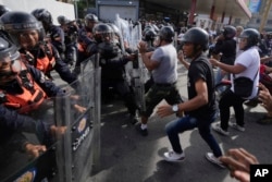 Protesters charge at police during demonstrations against the official election results, a day after electoral authorities declared President Nicolas Maduro victorious in Caracas, Venezuela, July 29, 2024.