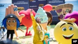 FILE - Actor T. J. Miller poses with characters for the film "The Emoji Movie," at the 70th international film festival, Cannes, May 16, 2017. 