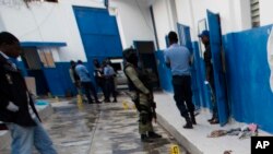 A guard lies dead inside the Civil Prison after a jail break in the coastal town of Arcahaiea, Haiti, Oct. 22, 2016. 