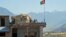 FILE - Two Afghan soldiers sit on a guard tower at a military base in Nari district, Kunar province, Afghanistan. 