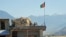 FILE - Two Afghan soldiers sit on a guard tower at a military base in Kunar province, Afghanistan, June 1, 2013.