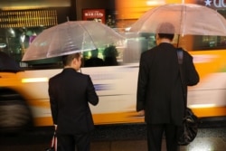 Commuters hold umbrellas at rush hour during a rain storm near Shinagawa Station in Tokyo, Japan, Oct. 11, 2019.