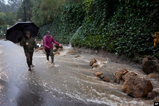Water gushes down a road during a storm February 5, 2024, in Studio City, California. (AP Photo/Marcio Jose Sanchez)