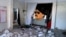 FILE - Pakistani children play next to the picture of Altaf Hussain, a top leader of Muttahida Qaumi Movement, or MQM, at one of his party offices demolished by authorities in Karachi Pakistan, Tuesday, Sept. 6, 2016. 