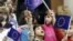 FILE - Bosnian children wave European Union flags at a celebration of European Day in the Bosnian capital Sarajevo, May 9, 2007.