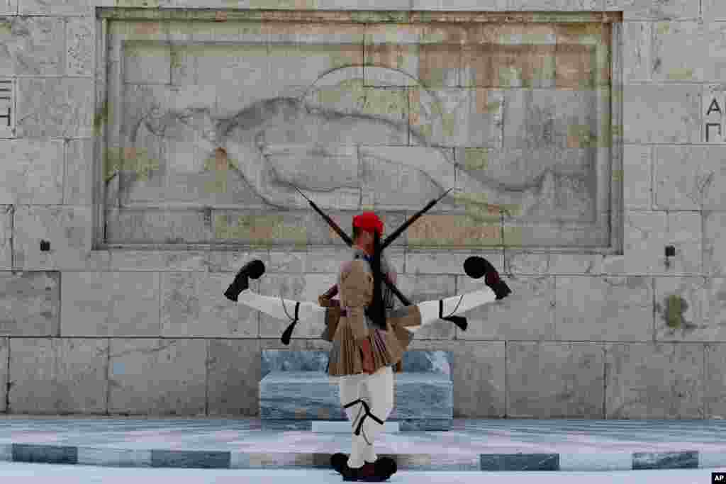 Evzones of the Greek Presidential Guard in front of the Tomb of the Unknown Soldier in Athens Greece.