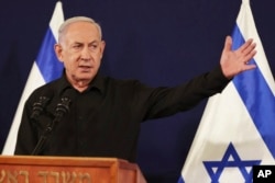 FILE - Israeli Prime Minister Benjamin Netanyahu speaks during a press conference in Tel Aviv on Oct. 28, 2023. Netanyahu has said that he thinks Israel will assume “overall security responsibility” for Gaza.