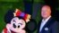 FILE - Chairman of Walt Disney Parks and Resorts Bob Chapek poses with Minnie Mouse during a ceremony at the Hong Kong Disneyland, Sept. 11, 2015.