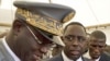 Senegal's newly inaugurated President Macky Sall (R) is surrounded by security as he leaves his swearing-in ceremony at a hotel in Dakar, April 2, 2012