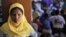 A Rohingya woman stands at a temporary shelter in Bayeun, Aceh Province, Indonesia, Monday, June 1, 2015. 