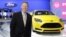 Ford President and CEO Alan Mulally stands by a Ford Focus during the North American International Auto Show in Detroit, Jan. 15, 2013.