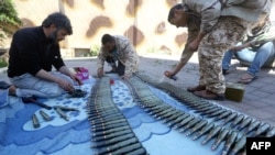 Fighters from a Misrata armed group loyal to the internationally recognized Libyan Government of National Accord (GNA) prepare their ammunition before heading to the front line. Taken 4.9.2019