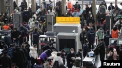 People go through security check at the entrance of a railway station during the annual Spring Festival travel rush ahead of the Chinese Lunar New Year, as the COVID-19 outbreak continues, in Shanghai, China Jan. 16, 2023. 