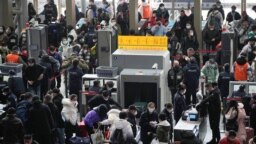 People go through security check at the entrance of a railway station during the annual Spring Festival travel rush ahead of the Chinese Lunar New Year, as the COVID-19 outbreak continues, in Shanghai, China Jan. 16, 2023.