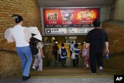 Ads for Chinese restaurants and karaoke, fashionable  among Chinese surviving  successful  Japan, are seen astatine  Ikebukuro station, Sept. 4, 2024, successful  Tokyo. China has utilized  intimidation to forestall  Chinese radical   surviving  successful  Japan from being activists, Human Rights Watch said.