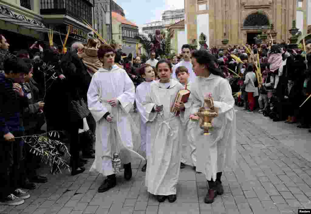 Young penitents attend a Palm Sunday procession in Pontevedra, northern Spain.