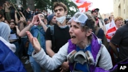 A demonstrator argues with police officers during an opposition protest of the foreign influence bill at the Parliamentary building in Tbilisi, Georgia, on May 28, 2024. The Georgian parliament overrode a presidential veto of the measure, which has sparked wide protests.