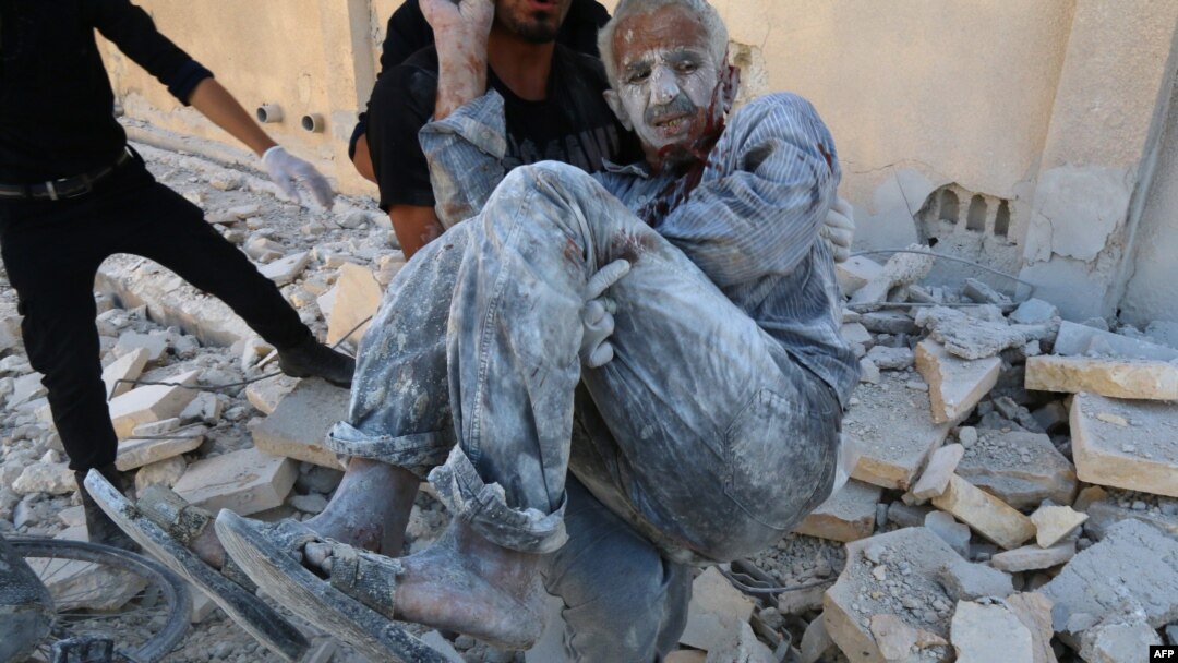 FILE - Syrian civil defense workers rescue a man from under the rubble after a Syrian government helicopter allegedly dropped a barrel bomb on the Sakhour eastern neighborhood, in the northern city of Aleppo, July 25, 2014.